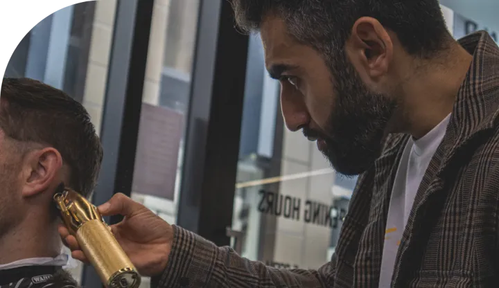 Expert Christchurch barber making finishing touches on groom styling before his wedding during a chch groomsman reservation.