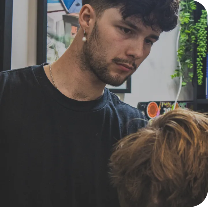 A man getting a fresh barber haircut during a groomsman party in chch,  wedding preparation and styling at the modern man barbershop in christchurch city.