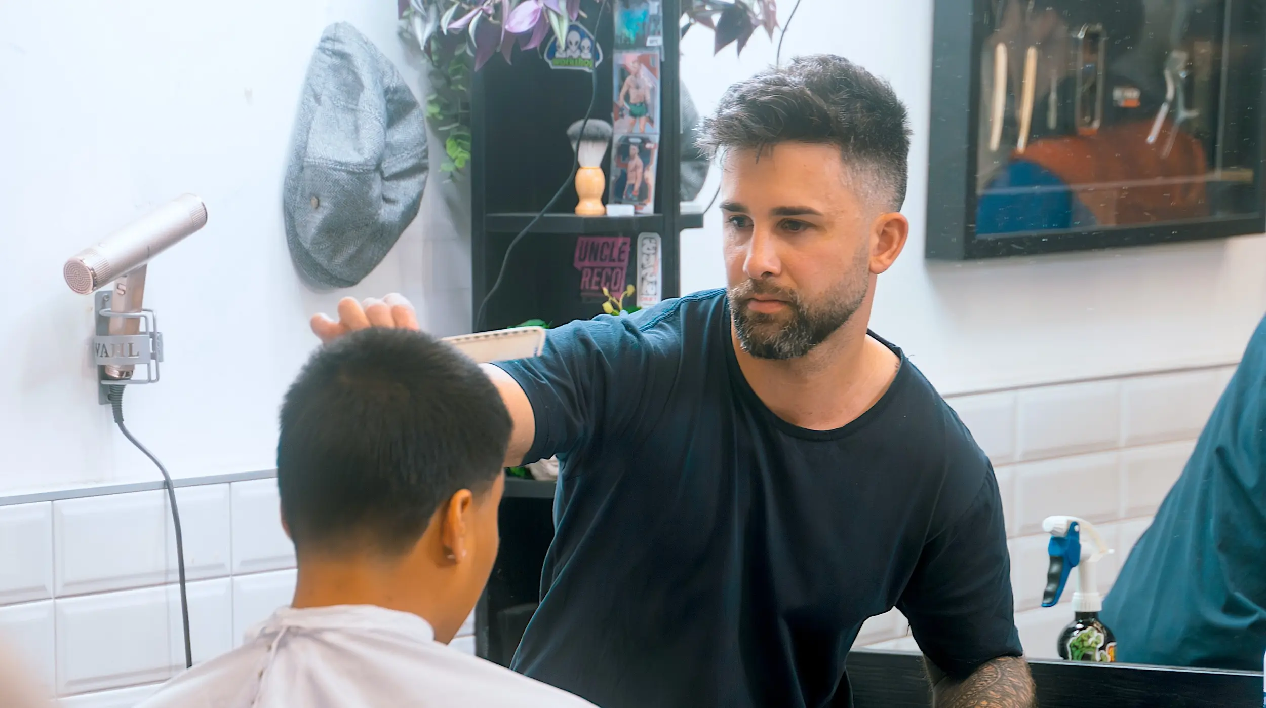 Jordan, co-owner of Modern Man barbershop, the best barbershop in chch CBD giving his regular client a trim.