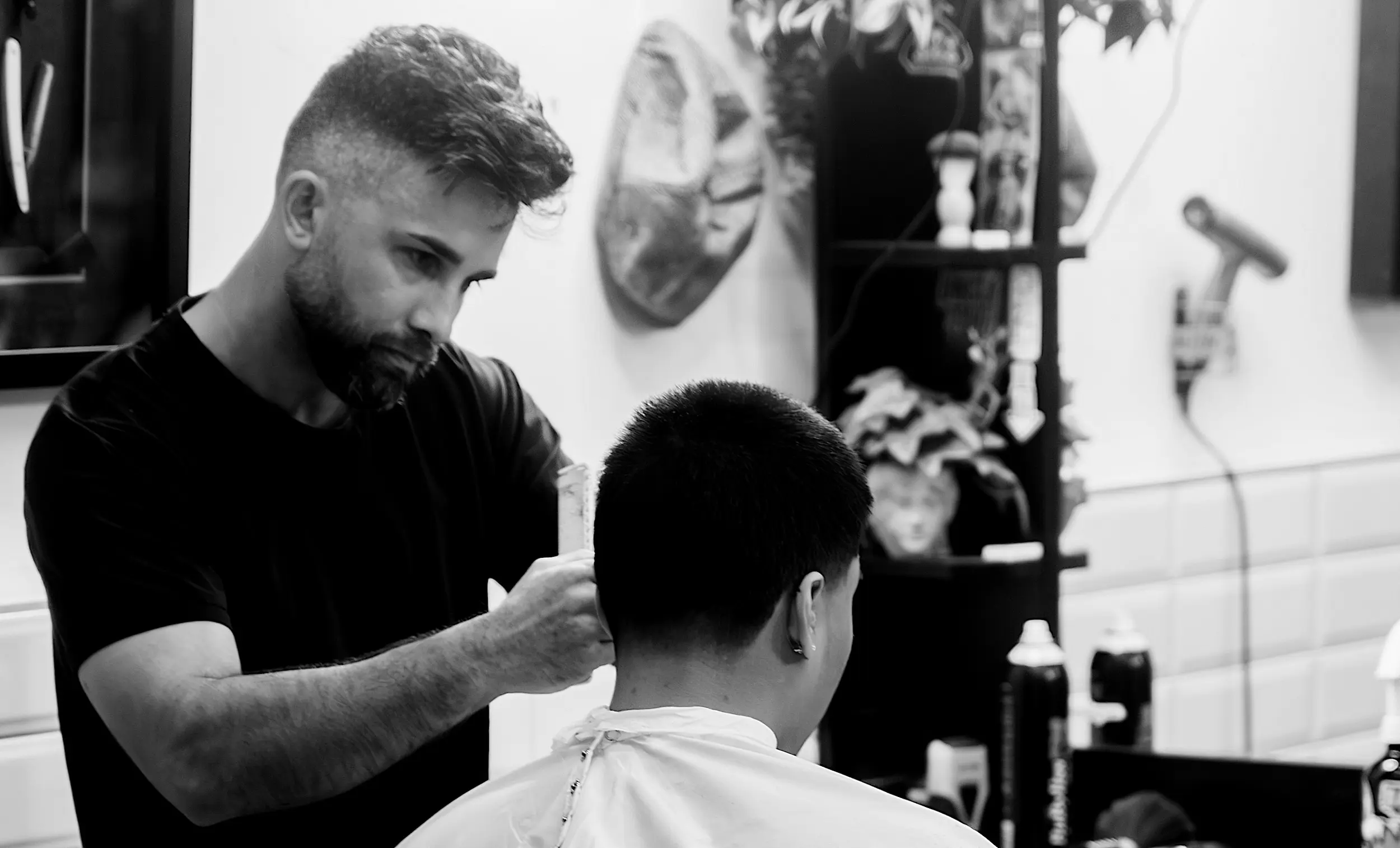 A person getting a straight shave during a groomsman party at modern man barbershop located in barkers at the crossing Christchurch cbd.